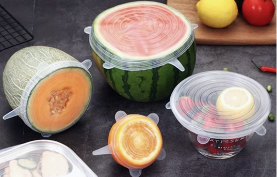 Various food containers with silicone lids on a dark surface, showcasing their flexibility and toughness.