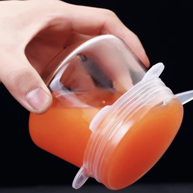 Hand holding an orange container with a silicone lid, emphasizing good adsorption and non-leaking performance.